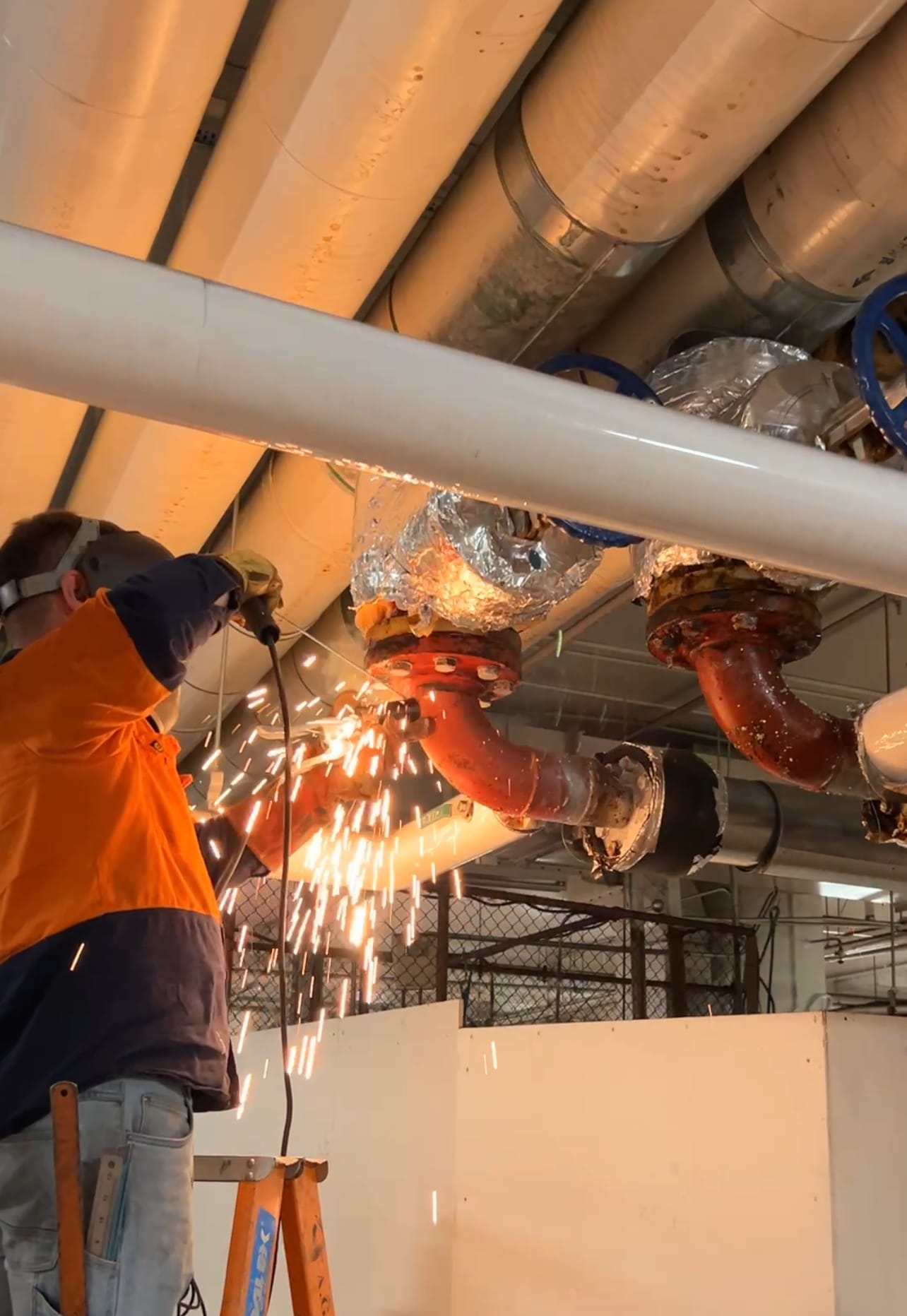 Man is welding a factory pipeline